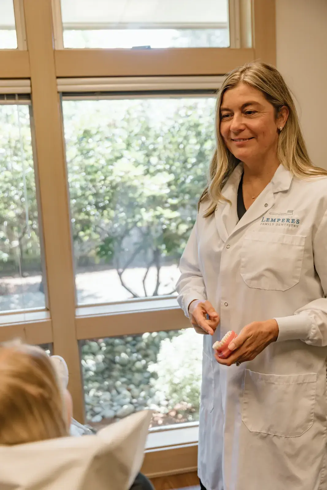 Dr. Collins reviewing a dental model with a patient